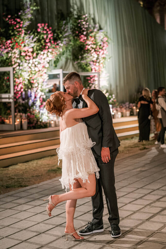 Romantic moment of bride and groom kissing at their luxury Las Vegas wedding reception at the Smith Center. 