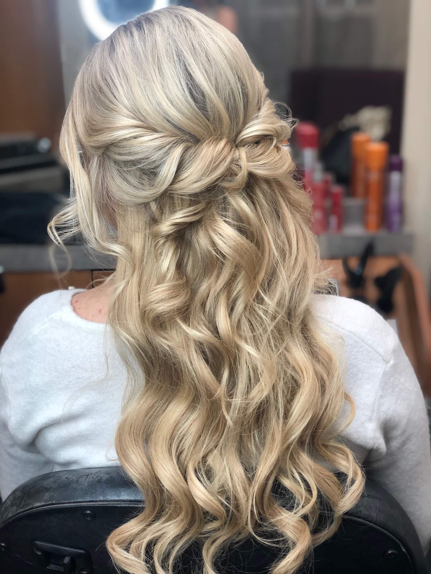 Half-up bridal hairstyle with soft curls by Elwynn and Cass